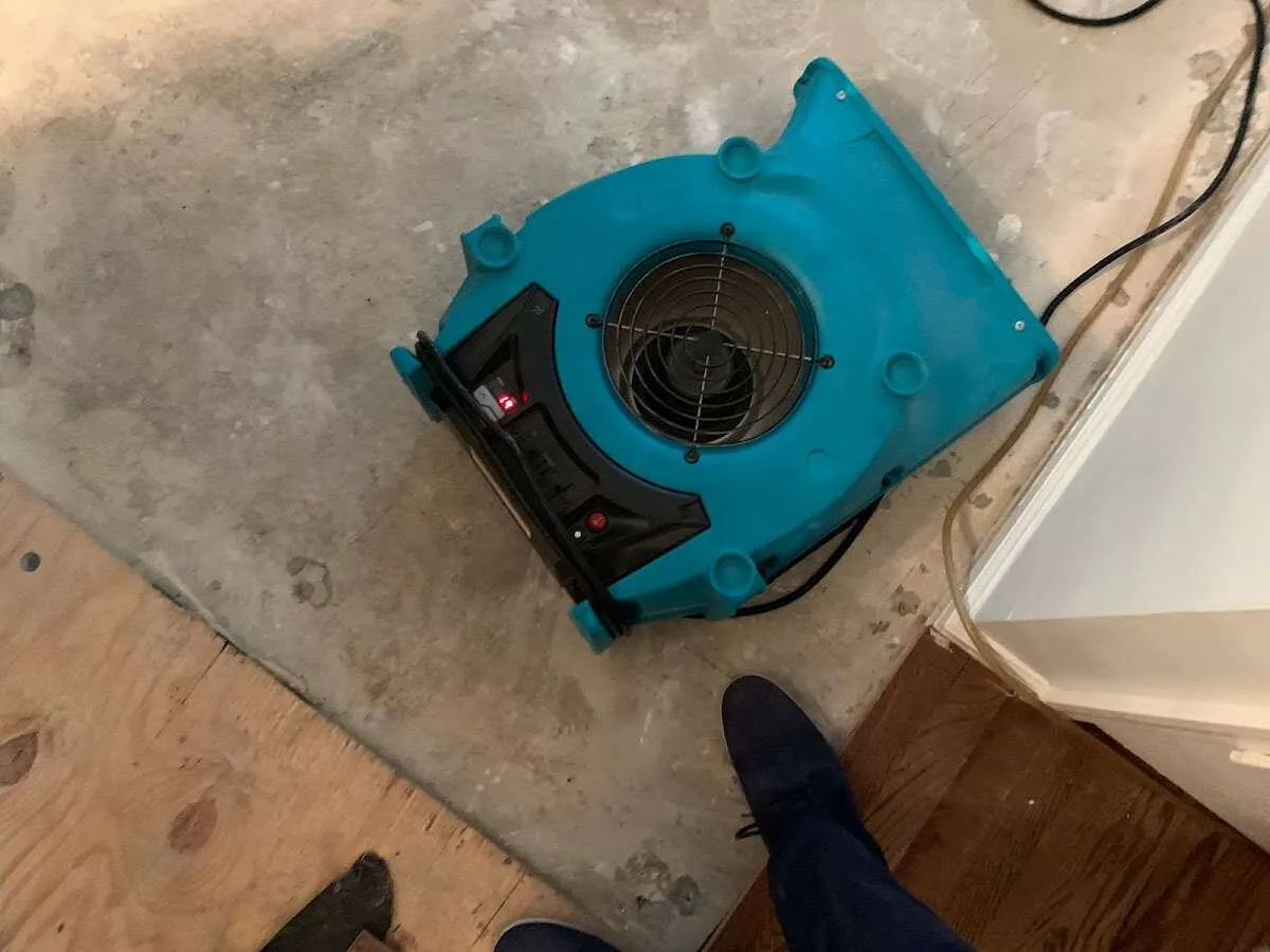 Air mover drying subfloor during Commercial Water Damage Restoration in Greensburg
